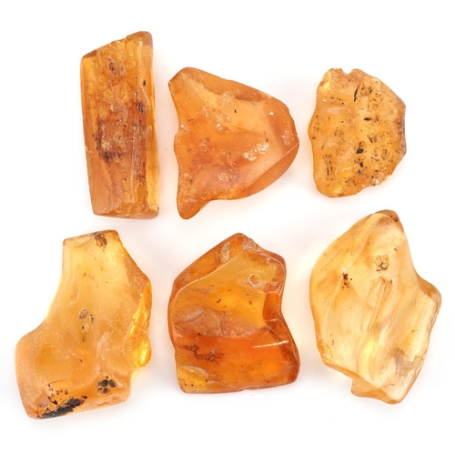 1274 - A group of six rough cut translucent amber shards, the largest 5cm in length