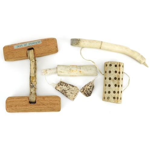 230 - Two Canadian Inuit items, late 20th century, one a wood and string handled strength game circa 1985 ... 