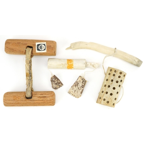 230 - Two Canadian Inuit items, late 20th century, one a wood and string handled strength game circa 1985 ... 