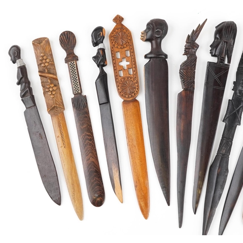 1213 - A collection of 19th century and later carved wood letter openers, predominantly African examples, t... 