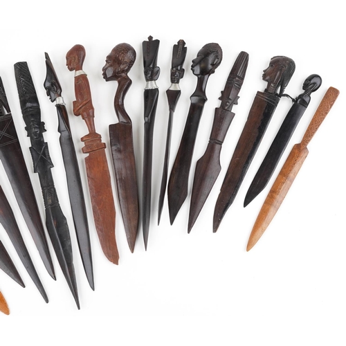 1213 - A collection of 19th century and later carved wood letter openers, predominantly African examples, t... 