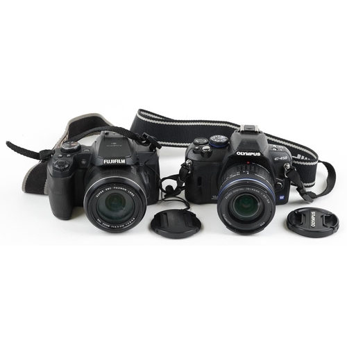 486 - Two digital cameras, one with box, comprising Fujifilm Finepix S1 and Olympus E-450.