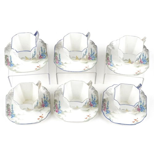 412 - A set of six Art Deco Shelley cups and saucers, each hand painted with flowers, pattern number 11606... 