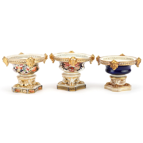 75 - Three 19th century Derby hand painted porcelain pot pourri vases, each lacking a cover, 10cm high