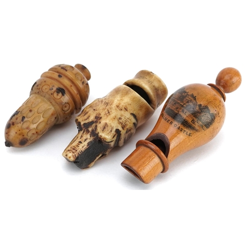 133 - A Victorian Mauchline ware whistle decorated with Walmer Castle, 8cm in length, together with a carv... 