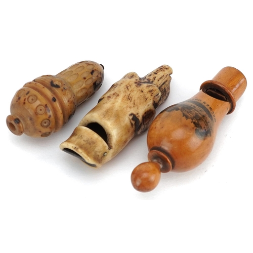 133 - A Victorian Mauchline ware whistle decorated with Walmer Castle, 8cm in length, together with a carv... 