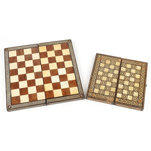 523 - A 20th century hardwood and inlaid folding chequer board, 47cm wide together with a similar smaller ... 