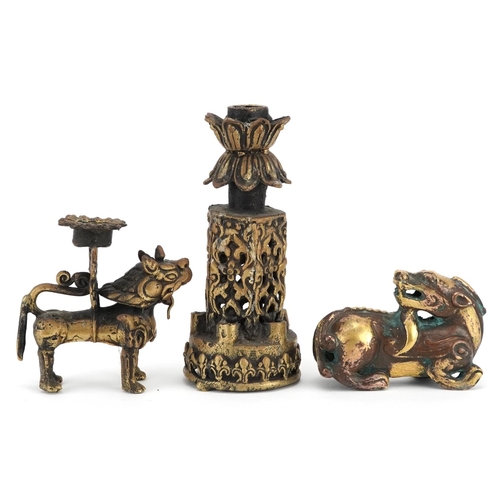 1195 - A group of three Chinese gilt bronze items, 20th century, including a temple dog and two candlestick... 