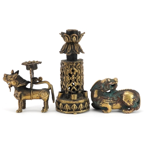 1195 - A group of three Chinese gilt bronze items, 20th century, including a temple dog and two candlestick... 