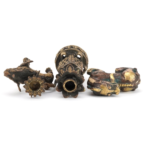 1195 - A group of three Chinese gilt bronze items, 20th century, including a temple dog and two candlestick... 