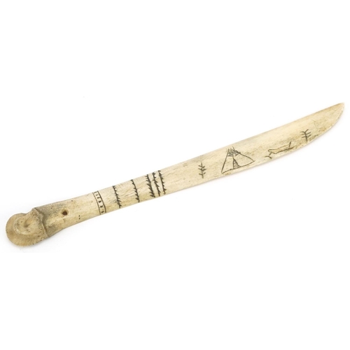 233 - An early 20th century Inuit carved bone knife with incised decoration, 23cm in length.