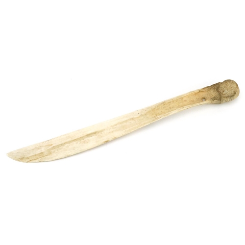 233 - An early 20th century Inuit carved bone knife with incised decoration, 23cm in length.