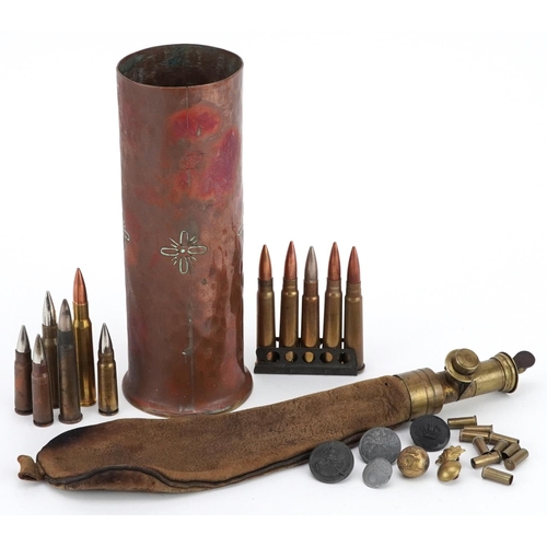 715 - A collection of militaria including trench art shell case, powder flask and ammunition shells.