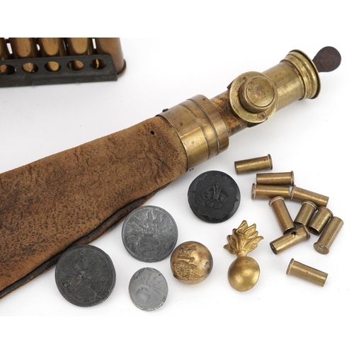 715 - A collection of militaria including trench art shell case, powder flask and ammunition shells.