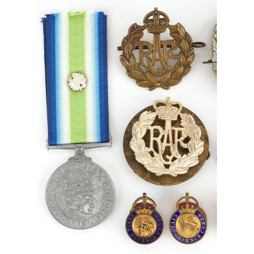 704 - A collection of British military interest cap badges, buttons and a South Atlantic style medal.