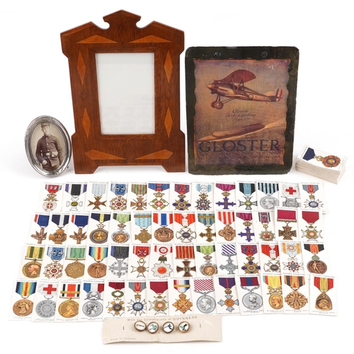 714 - Militaria and sundry items including a Welsh slate panel decorated with a bi-plane, inlaid photo fra... 