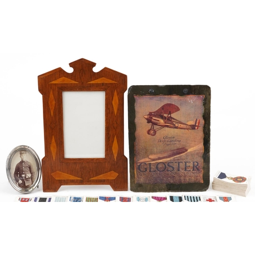 714 - Militaria and sundry items including a Welsh slate panel decorated with a bi-plane, inlaid photo fra... 