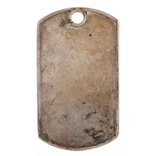 2525 - A Gucci silver dog tag pendant, 5cm high, 19.2g.