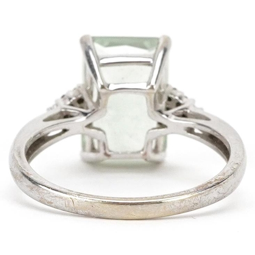 2011 - A 9ct white gold pale green stone ring with diamond set shoulders, size P, 3.4g.