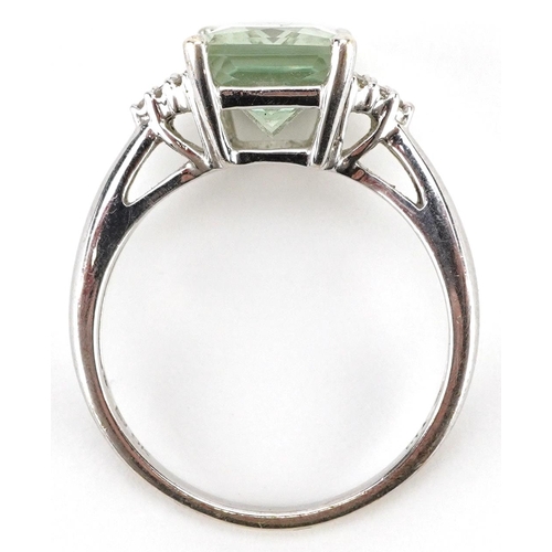 2011 - A 9ct white gold pale green stone ring with diamond set shoulders, size P, 3.4g.