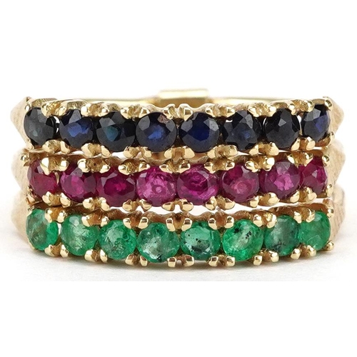 A 9ct gold triple half eternity ring set with emeralds, rubies and sapphires, size L/M, 3.4g.