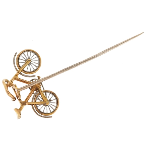 2068 - An antique unmarked gold and platinum stickpin in the form of a bicycle set with diamonds, having ro... 