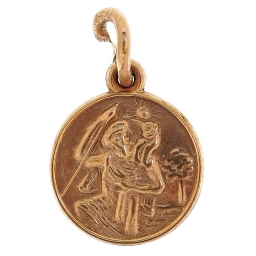 2503 - A 9ct gold St. Christopher charm, 9.7mm in diameter, 0.9g.