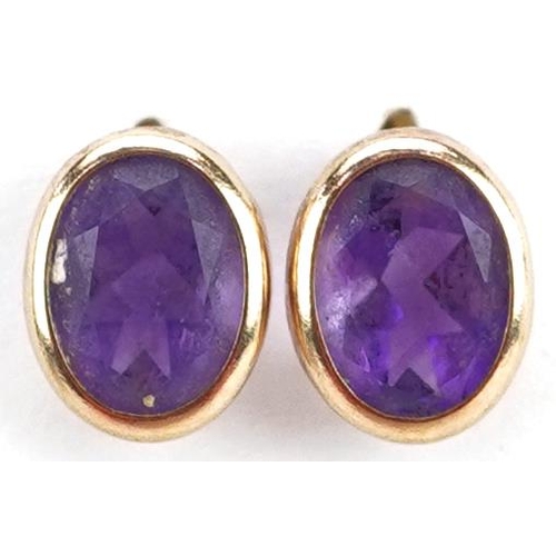 2356 - A pair of yellow metal and amethyst earrings, 1cm high, total weight 0.9g.