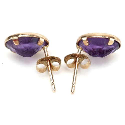 2356 - A pair of yellow metal and amethyst earrings, 1cm high, total weight 0.9g.