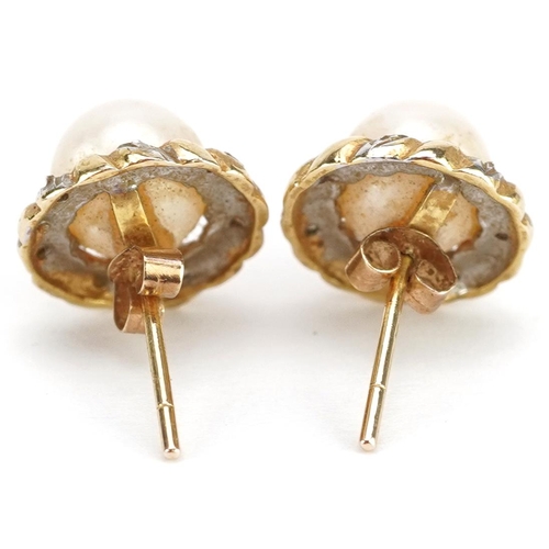 2331 - A pair of unmarked gold cultured pearl and diamond stud earrings, the pearl 7.5mm in diameter, overa... 