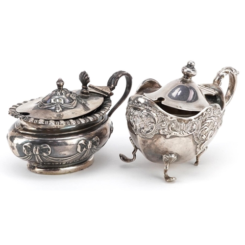 196 - Two Victorian silver mustards with embossed decoration, one with blue glass liner, Birmingham 1898, ... 