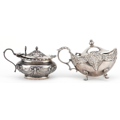 196 - Two Victorian silver mustards with embossed decoration, one with blue glass liner, Birmingham 1898, ... 