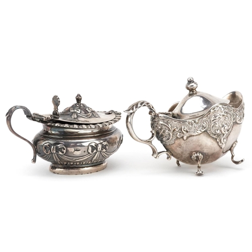 196 - Two Victorian silver mustards with embossed decoration, one with blue glass liner, Birmingham 1898, ... 