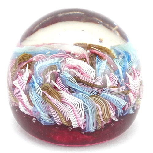 124 - A vintage Murano latticino glass paperweight with pink, white, blue and yellow canes, 7.5cm in diame... 