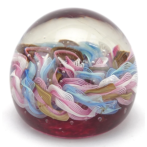 124 - A vintage Murano latticino glass paperweight with pink, white, blue and yellow canes, 7.5cm in diame... 