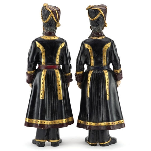 338 - A pair of cold painted bronze figures of Russian officers in military dress, the largest 39cm high.