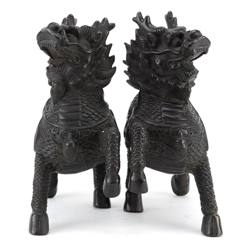 350 - A pair of Chinese patinated bronze figures in the form of a horse with a dragon heads, character mar... 