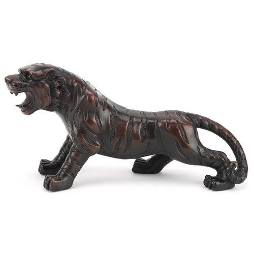 351 - A Japanese patinated bronze okimono figure of a tiger, 33cm in length.