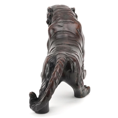 351 - A Japanese patinated bronze okimono figure of a tiger, 33cm in length.