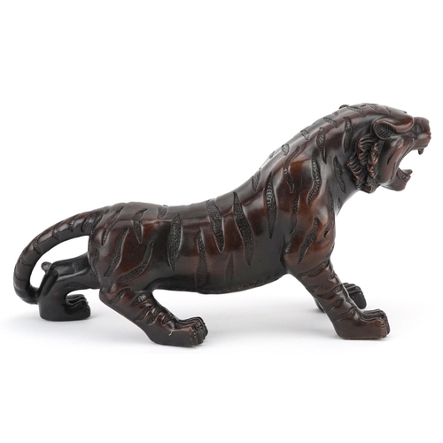 351 - A Japanese patinated bronze okimono figure of a tiger, 33cm in length.