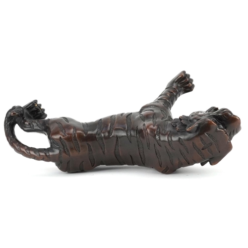 351 - A Japanese patinated bronze okimono figure of a tiger, 33cm in length.