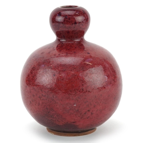 1323 - A Chinese sang de boeuf style pottery vase, 16cm high.