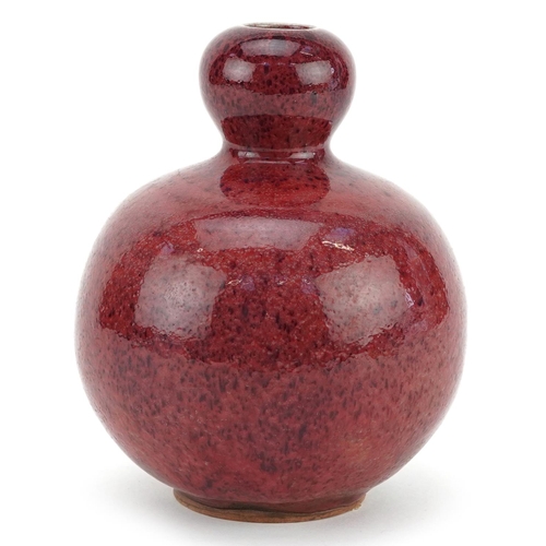 1323 - A Chinese sang de boeuf style pottery vase, 16cm high.