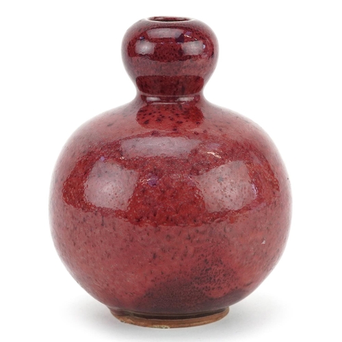 1323 - A Chinese sang de boeuf style pottery vase, 16cm high.