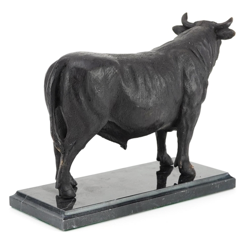 342 - A patinated bronze study of a bull raised on a black marble base, 26cm in length.