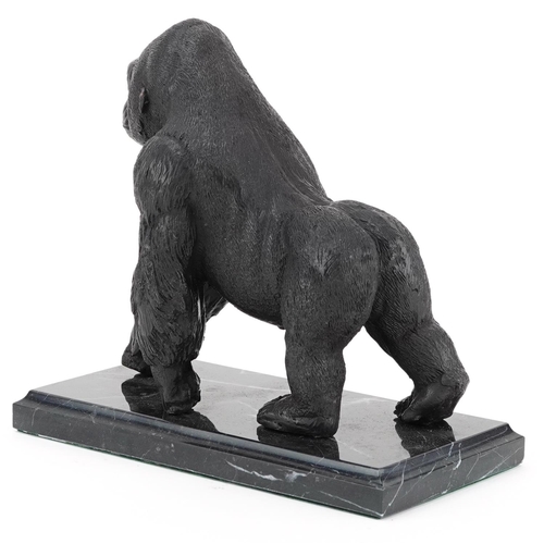 341 - A patinated bronze study of a gorilla, raised on a black marble base, 20cm in length.