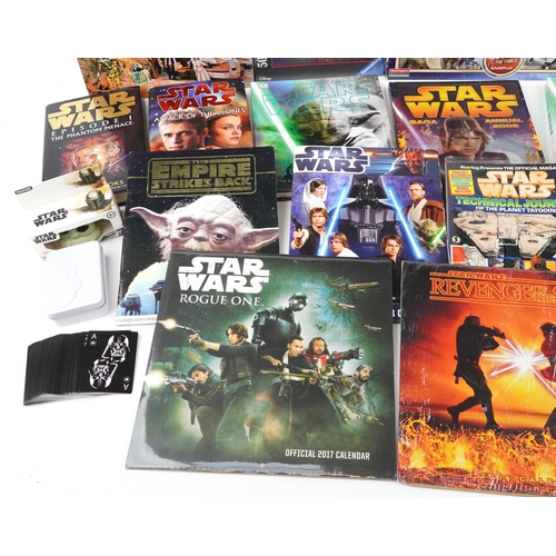 580 - Star Wars memorabilia including a collection of hardback books, calendars, Star Wars Monopoly and St... 