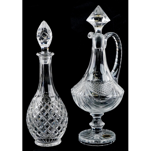 1163 - A large Veristable Cristal claret jug, 40cm high, together with a cut glass decanter, 38cm high.