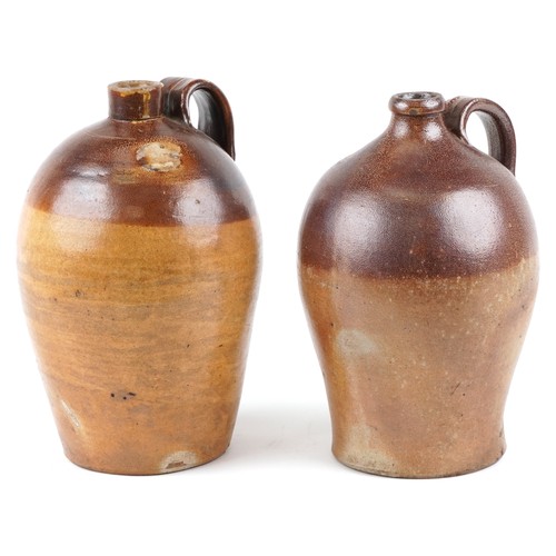 1292 - Two similar late 19th century stoneware flagons, probably by Doulton Lambeth, 38cm high.