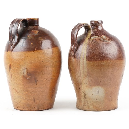 1292 - Two similar late 19th century stoneware flagons, probably by Doulton Lambeth, 38cm high.